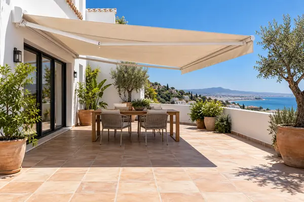 Qué toldo quita más el calor Qué toldo quita más el calor: sombra de un toldo con lona color arena sobre una terraza en verano